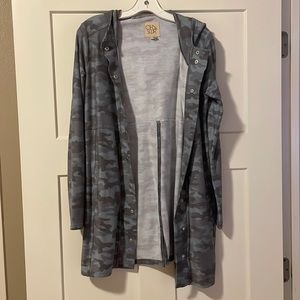 Small Size, never worn and in great condition, hood, pockets and buttons up.